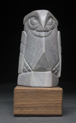 A photo of Soapstone Owl #19, a thin owl on an oak base