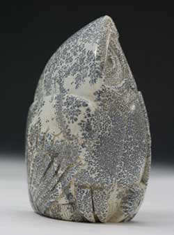 A photo of Soapstone Owl #22F on a cherry base by Clarence P. Cameron