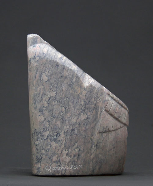A view of the back of Soapstone Owl #14 by Clarence P. Cameron of Madison, Wisconsin