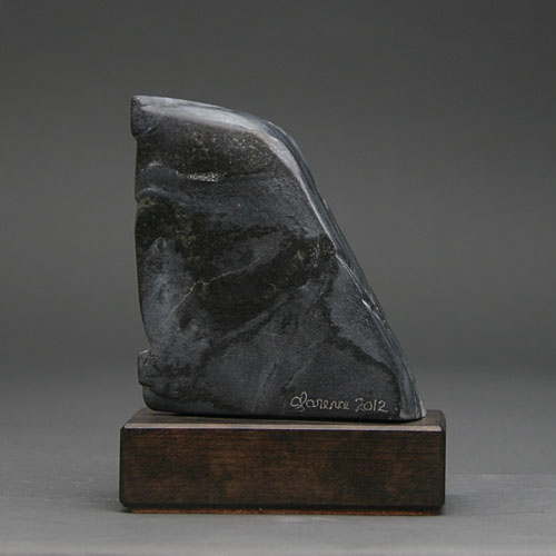 A view of the back of Soapstone Owl #29 by Clarence P. Cameron